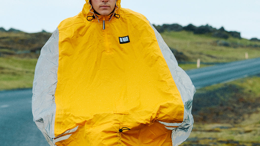 Cyclist wearing breathable rainwear during a rainy commute