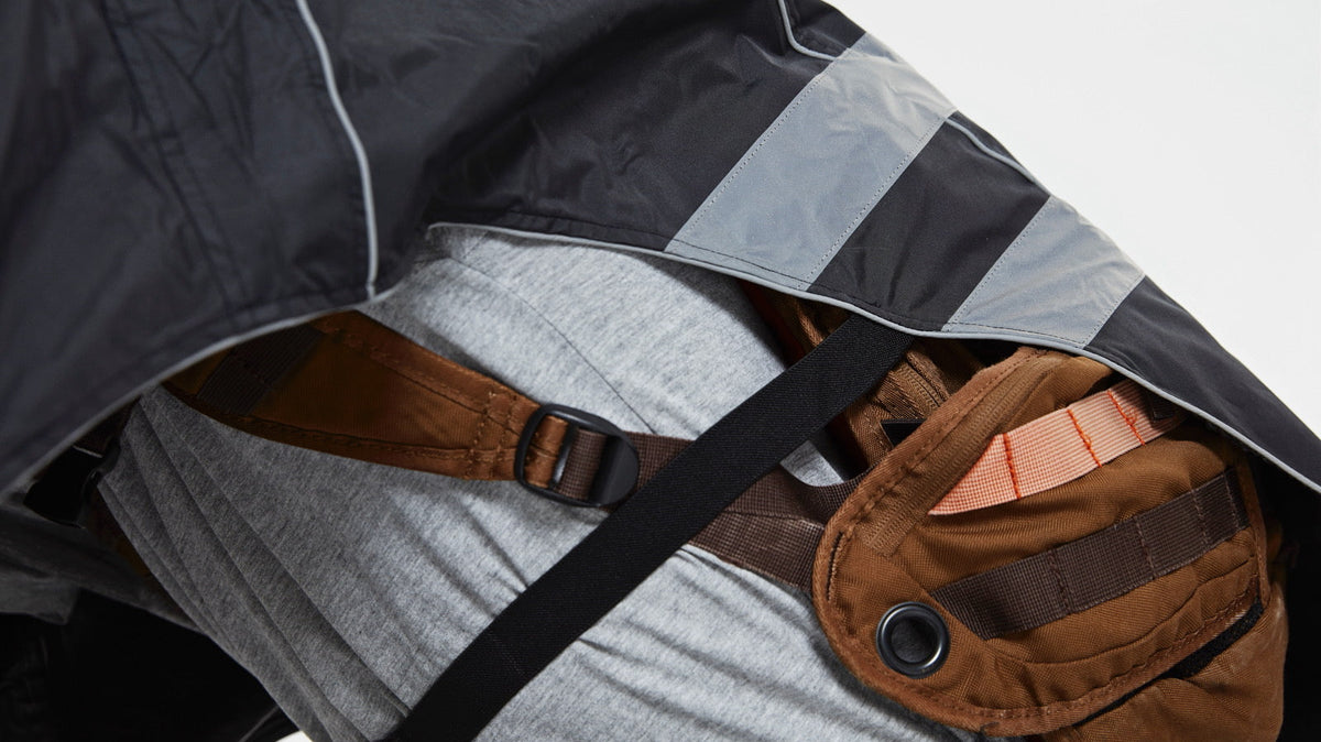 Cyclist commuting with a backpack containing a laptop in rainy weather