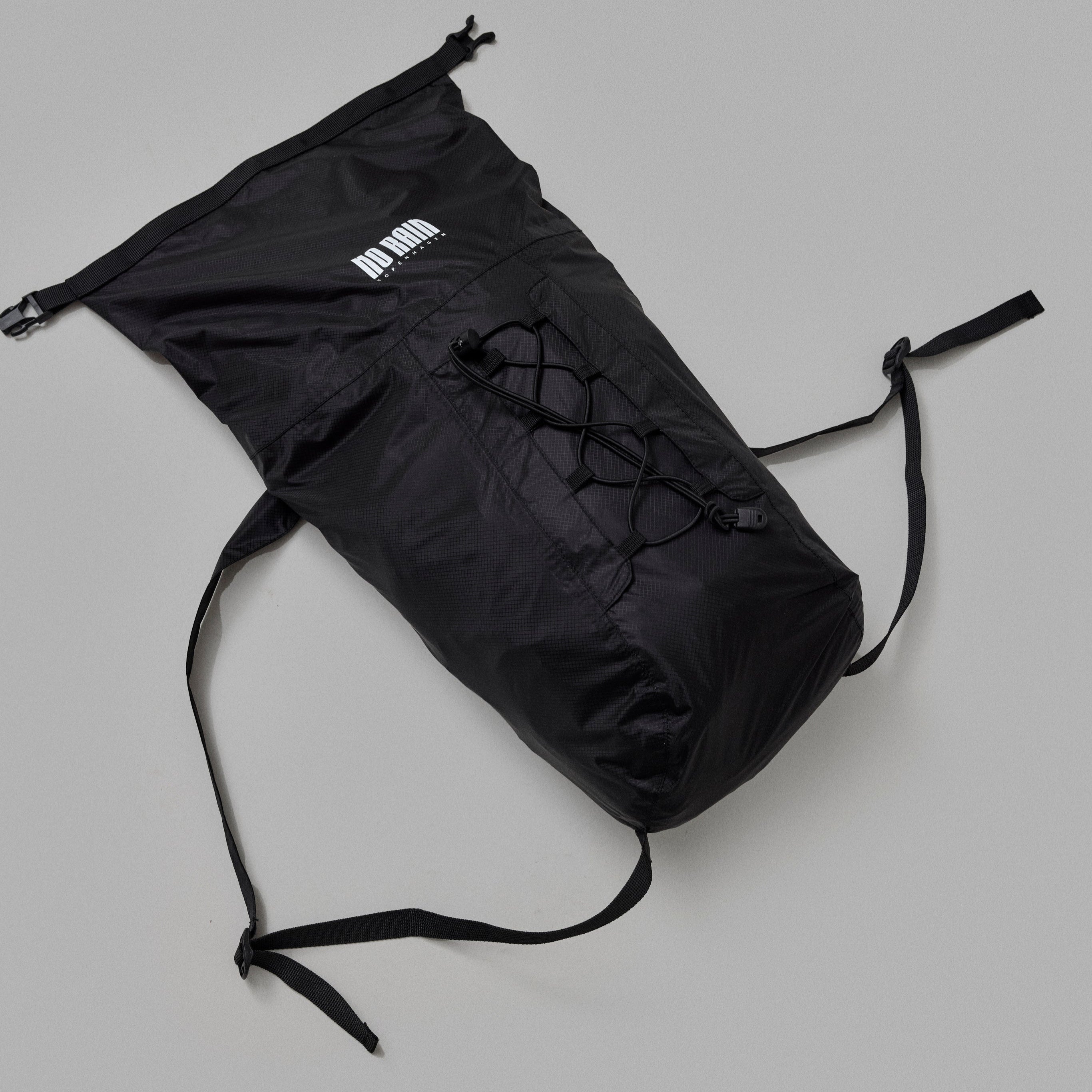 Black drawstring bag on a gray background