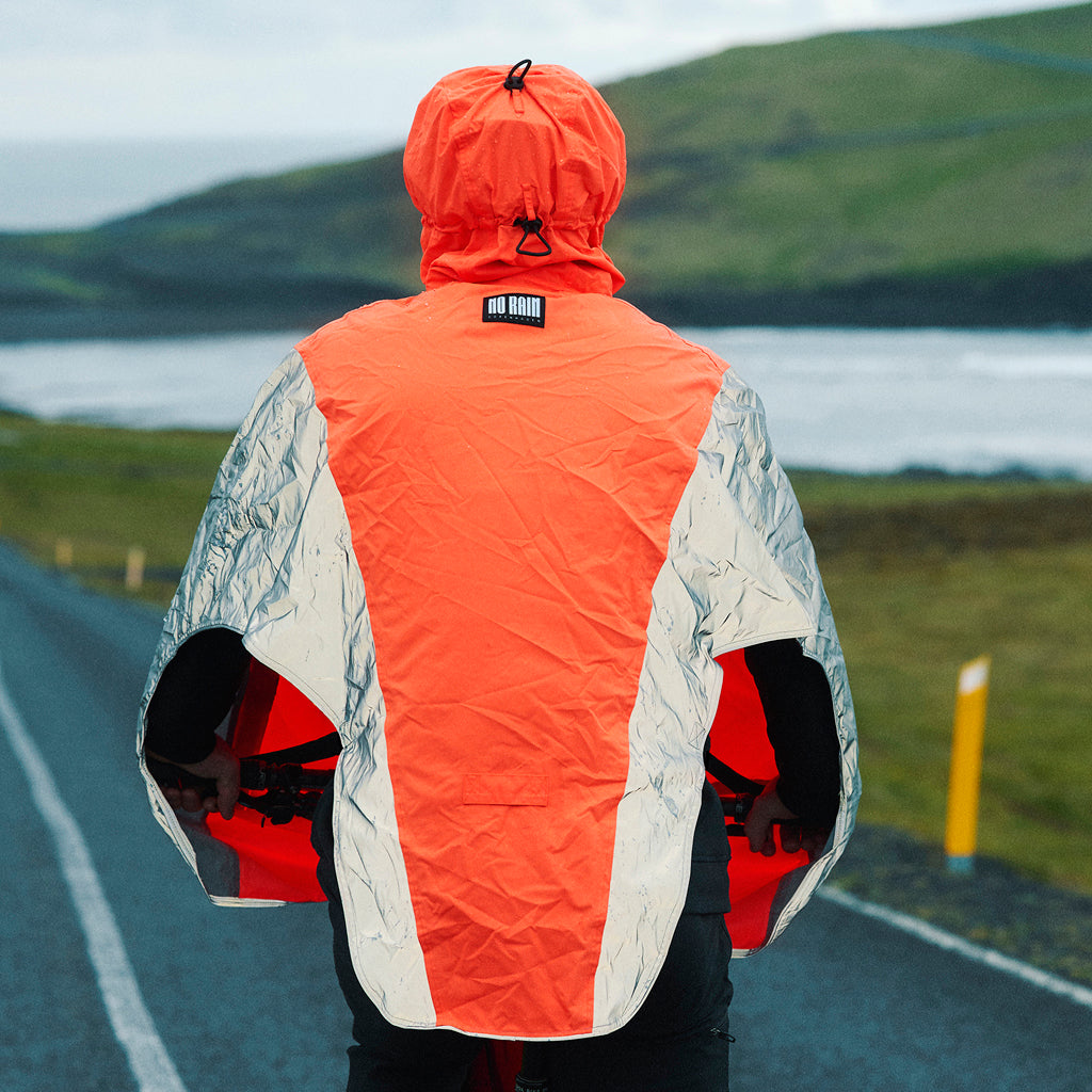 Cyclist riding through the rain with waterproof protection for legs and feet