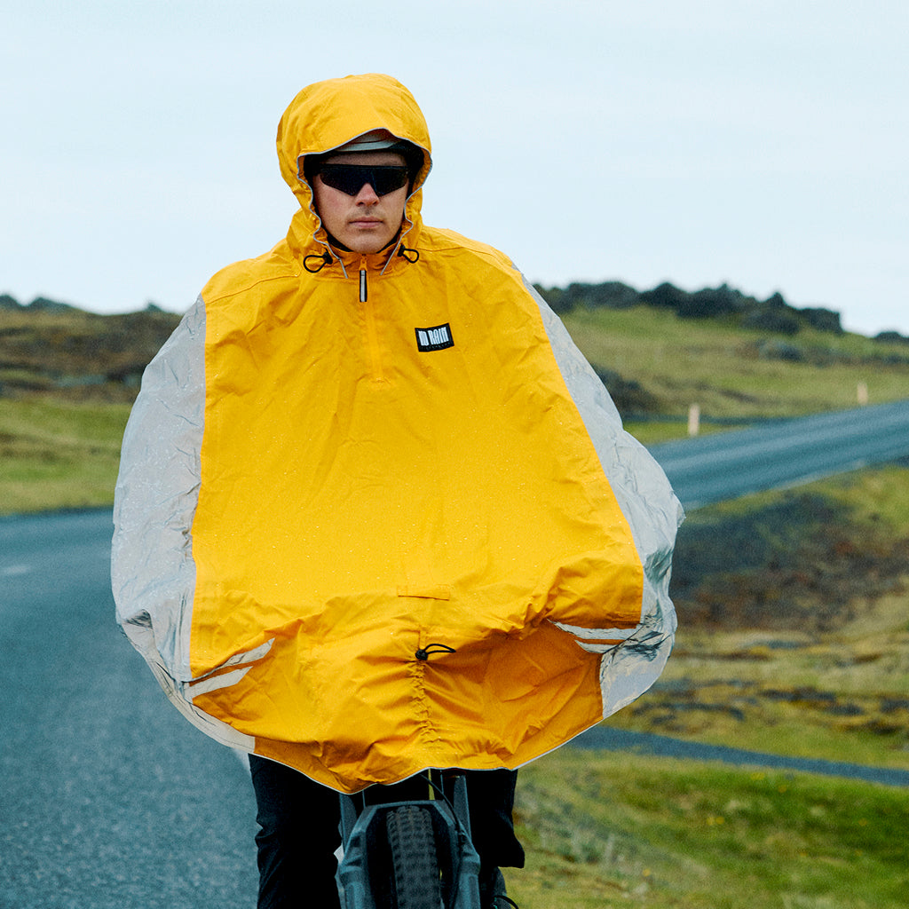 Cyclist wearing breathable rainwear during a rainy commute