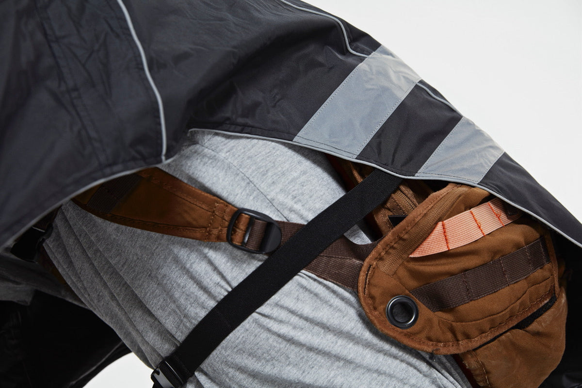 Cyclist commuting with a backpack containing a laptop in rainy weather