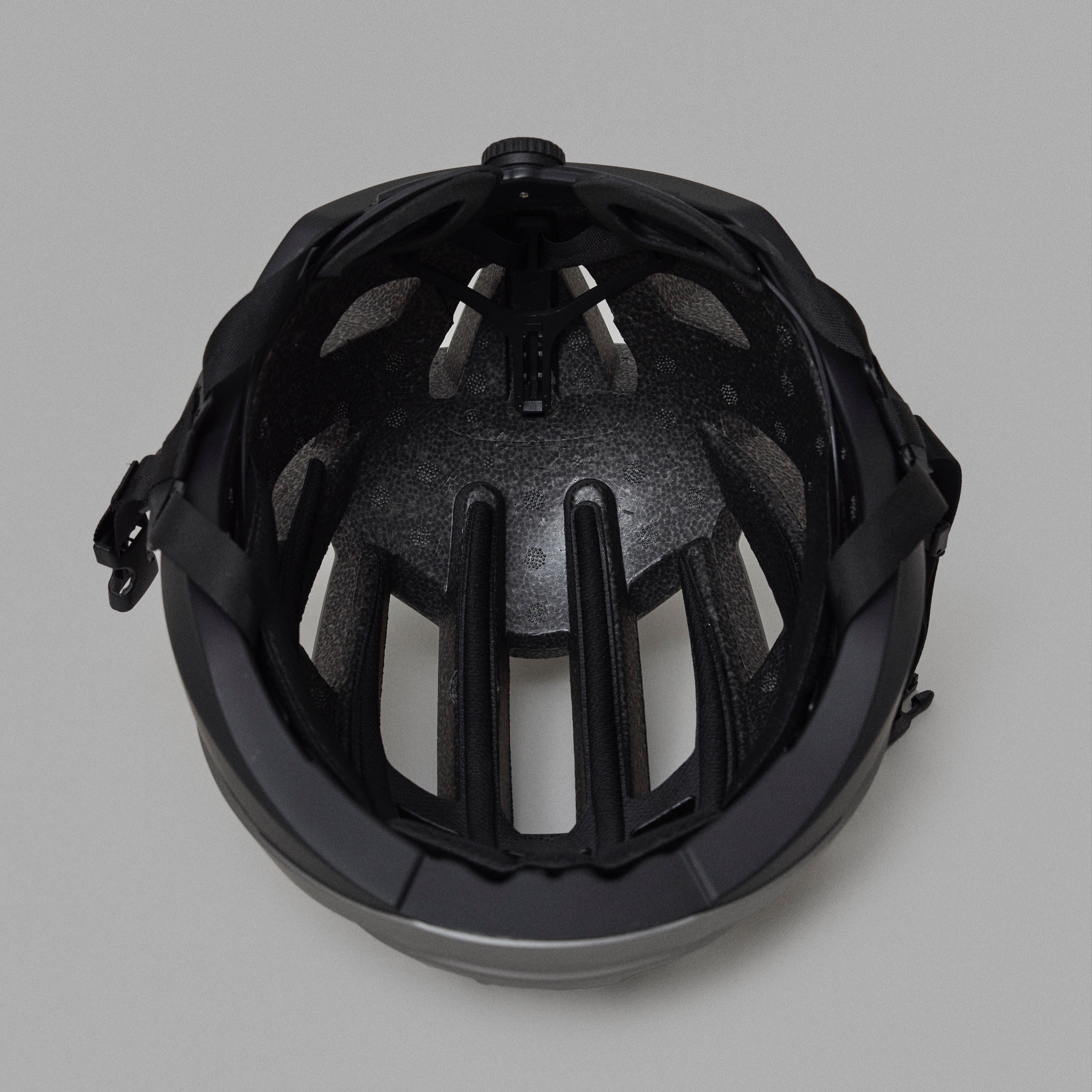 Black NoRain Bicycle helmet with cage on a gray background