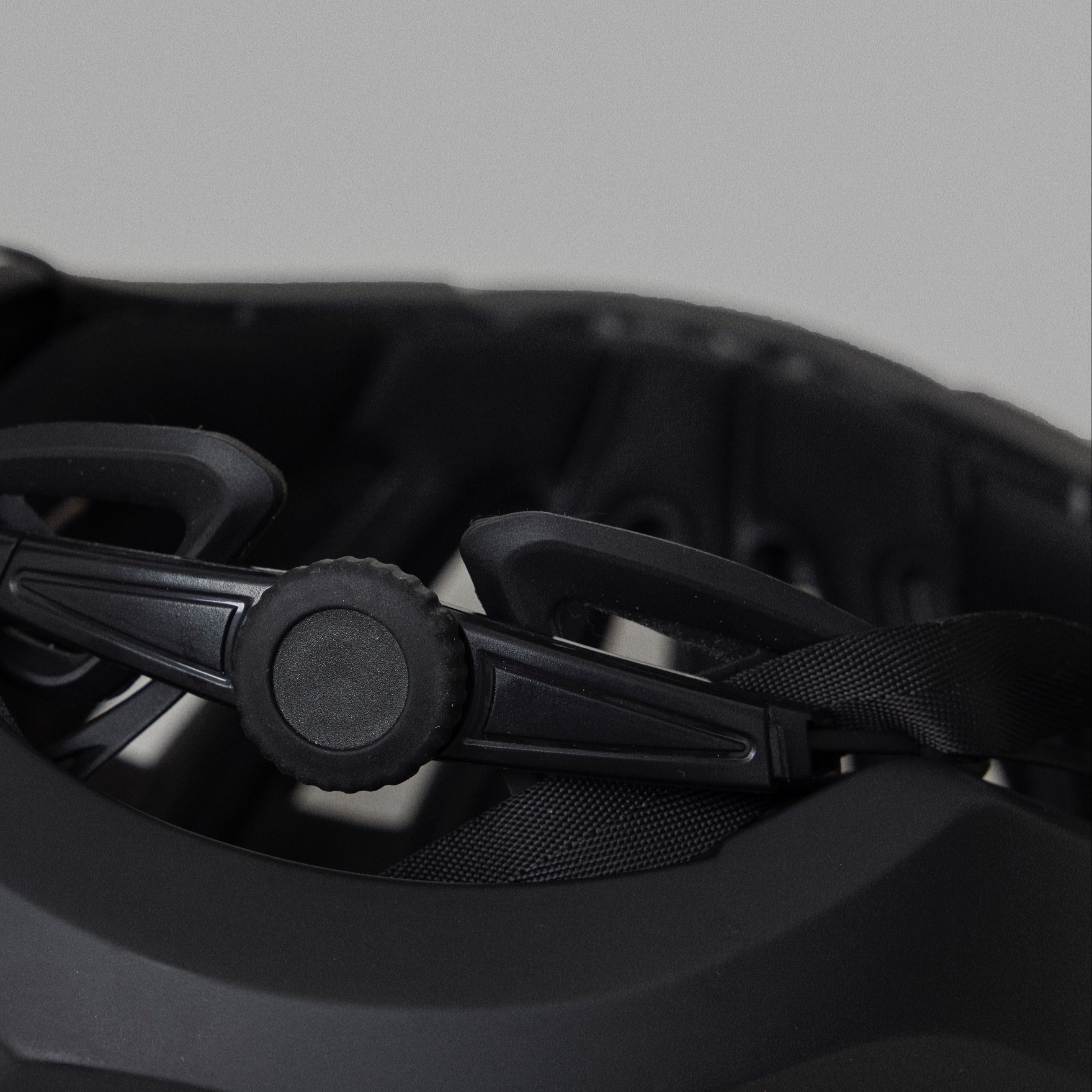 Black NoRain Bicycle helmet with a focus on the front design on a gray background