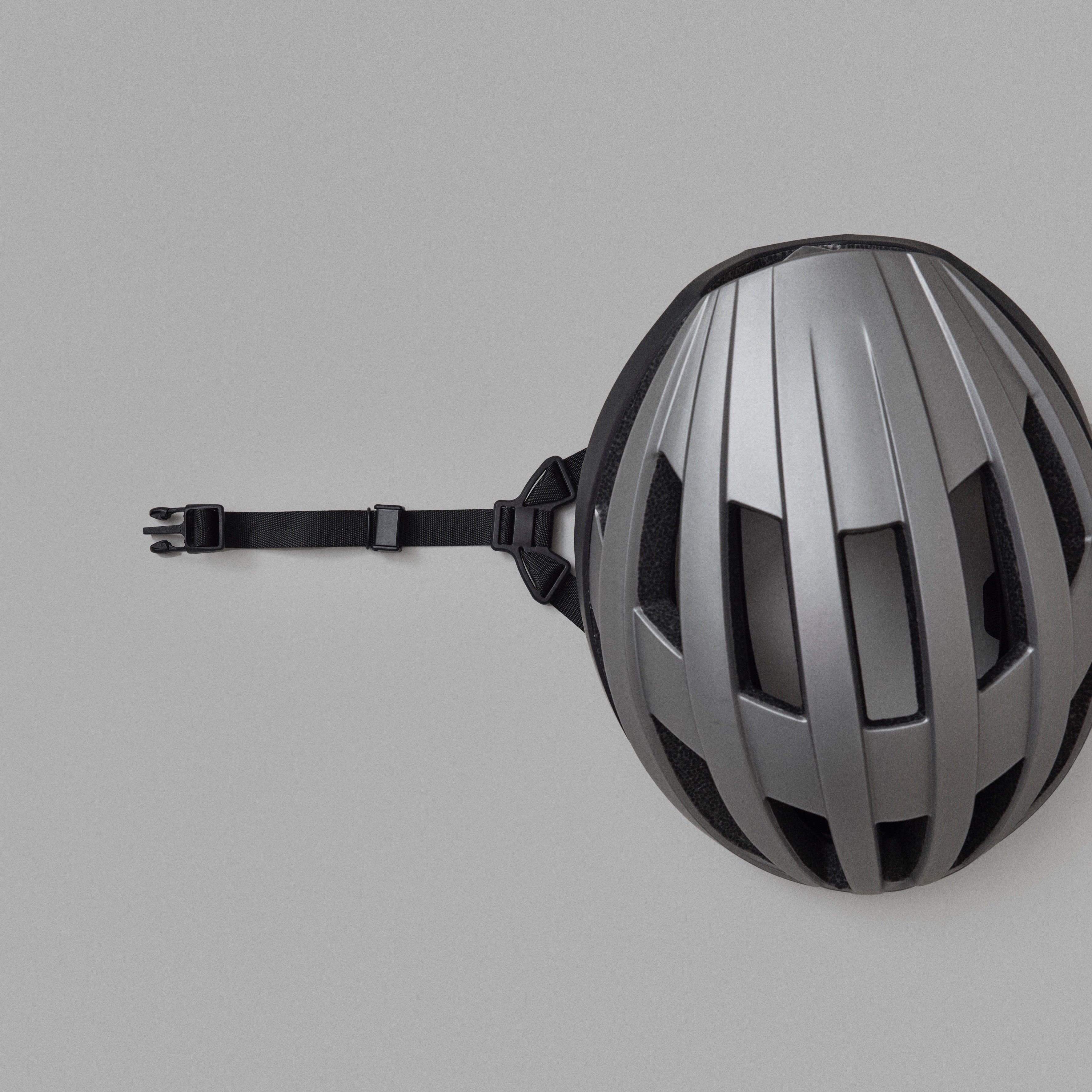 Silver and black NoRain helmet on a gray background