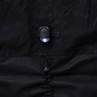 Close-up of a black NoRain Bicycle poncho with a light on the chest area.