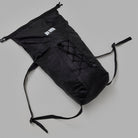 Black drawstring bag on a gray background